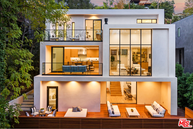 16530 Akron Street Pacific Palisades, California Stunning design-driven new construction in the Palisades! This 3-story architectural masterpiece is a study in balance, drawing in abundant natural light and the surrounding lush greenery, while providing the utmost privacy, luxury & comfort. Open concept floor plan features glass sliders, seamlessly incorporating 1300 s.f. of balconies and providing that quintessential indoor/outdoor lifestyle. Upstairs ultra-chic primary suite with private tree-top balcony, spa-like bath & oak clad walk-in closet. Middle level showcases a chef's kitchen with Thermador appliances, adjacent living, dining & deck areas plus a flexible space for your home office or gym. Lower level has 3 more beds, a den that leads to the grand deck, and a grass yard. Designer details & finishes include Dornbracht bath fixtures, Ann Sacks tile, flamed marble slabs, leathered granite counters & a Control4 smart home system. Set in a serene canyon close to hiking, farmers market, Palisades Village, and beaches.
