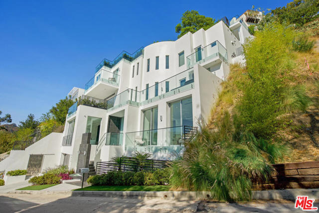 9459 Beverly Crest Drive Beverly Hills, California Architectural masterpiece in Lower BHPO. Seamless open floor plan. Walls of glass open to multiple patios ideal for entertaining large or small groups. Chefs kitchen has Miele appliances and breakfast bar with seating for six. Master suite is the ultimate retreat, spanning one entire level of the home. Spacious master bath overlooks verdant canyon views. Two-story rooftop deck features jaw-dropping views, fully equipped kitchen with BBQ and multiple lounge areas for dining and entertaining. Upper level boasts a one of a kind oasis with infinity pool. Three additional en-suite bedrooms with views and a lower level lounge with wet bar complete this exceptional home. Moments from amazing shopping and restaurants...