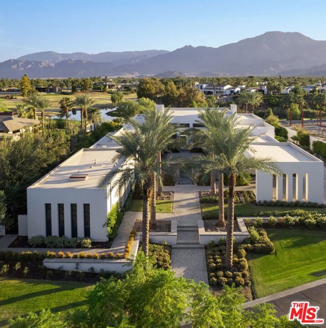 81347 Columbus Way La Quinta, California Stunning Southwest facing contemporary at the exclusive Madison Club. Enter thru the courtyard to a dramatic cascading water feature into a long pool and fire features leading to the all glass front with dramatic views of the mountains and world class Tom Fazio designed golf course. This expansive home offers 6 bedrooms and 6.5 baths consisting of two master suites, 2 guest suites and 2 separate casita suites. Open floor plan with a sunken bar, kitchen and large living area all open with receding walls of glass for seamless indoor/outdoor flow. The gourmet chef's kitchen offers a warm lacquered wood finish, large island with breakfast bar and top-of-the-line appliances. Both lavish master suites with fireplaces, soaking tubs, spa-like baths, spacious double vanities and walk-in closets. Custom outdoor barbecue and cook center and covered outdoor living space are perfect for large scale entertaining day and night. Swimmer's pool and spa complete this compound with a design ideal for multiple guests or a large family.