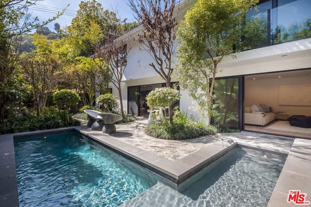 1712 BEVERLY Drive Beverly Hills, California This magnificent newly remodeled contemporary home, designed by international renowned Malgosia Migdal ASID, CID and close to Coldwater and Franklin Canyon Park, offers unparalleled quality in both craftsmanship and design. The sophisticated 5 bedroom, 5 1/2 bathroom property includes a chef's kitchen with top-of-the-line appliances, light-filled open dining area and family room, which all have sliding glass doors opening to a serene and magical backyard. The upper level master retreat features a balcony overlooking the pergola and the lap pool and has an elegant expansive modern master bath and a large steam shower. Each of the four additional bedrooms have en-suite bathrooms. Other features include a smart home and surround sound system, alarm, a sizable laundry room and moreYou don't want to miss out on this stunning celebrity retreat!