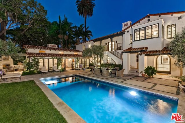 523 N Roxbury Drive Beverly Hills, California 1929 Spanish masterpiece in the highly esteemed Beverly Hills Flats. Thoughtfully restored w/high-end, custom finishes. Rarely does a home embody both warmth & contemporary aesthetics. The stunning 2-story foyer w/gleaming walnut floors leads to a series of impressive spaces, all opening to manicured grounds. The formal living room w/vaulted beamed ceiling is centered around a large fireplace of reclaimed limestone. The open concept kitchen exceeds expectations w/custom millwork & professional grade appliances including a Subzero refrigerator & Lacanche range. Four of the 5 bedrooms have exquisite ensuite baths. The oversized primary bedroom includes an elegant marble fireplace. The sparkling saltwater pool/spa, built-in BBQ & fireplace provide wonderful entertaining possibilities. Each detail, from the original features to the luxe modern touches, has been meticulously curated by Jenny Miller Studio. Sited on a corner lot, this is a rare opportunity for the most discriminating buyer.