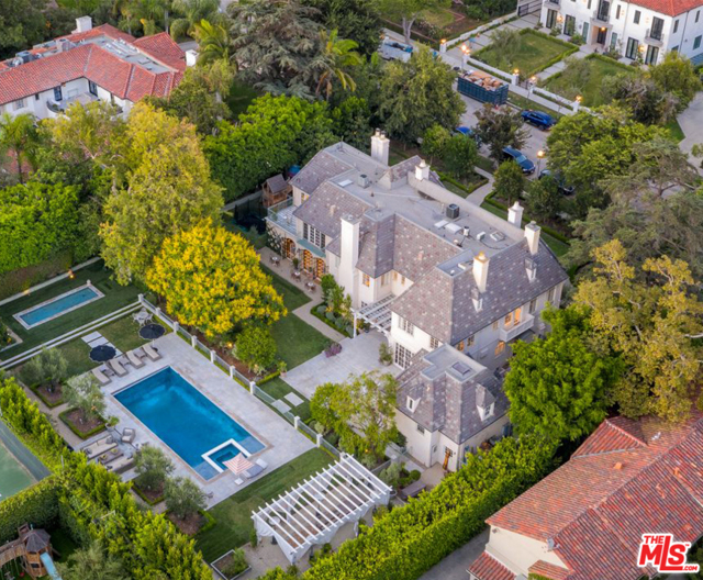 355 S Rimpau Boulevard Los Angeles, California Located on one of the most desirable streets in Hancock Park, this renovated chateau offers a premier living experience. This 6BD8BA home was tastefully reimagined to offer modern amenities while maintaining the original charm & architecture. Enter through a dramatic foyer leading to many highlights including sensational living & dining rms, chefs kitchen, wood-clade library &a bar that opens to the backyard made for dining al fresco. The master suite is the ultimate escape w/ cozy sitting room, gorgeous bathroom & balcony overlooking the gardens. Every inch was meticulously redone from the attic room/office to the basement wine cellar. This sprawling 32,000SF lot is an entertainers paradise boasting a swimmers pool&spa, fireplace, dining area, vegetable & flower gardens &a reflection pond all privatized by mature landscaping. To finish, find a beautiful guest suite w/ full bath &kitchenette. Rare opportunity to own a gem in this area, moments from the best dining &entertainment in LA.
