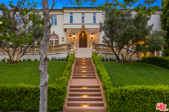 619 S June Street Los Angeles, California This stunning Mediterranean estate in the heart of Hancock Park was meticulously reimagined for the owners' personal use with the perfect combo of character & quality. The grand foyer boasts a historic preserved stained glass ceiling & extravagant crystal chandelier. Custom oak elements such as the solid French oak doors & herringbone flooring to the curved wooden staircase w/ metallic wire railings offer a nostalgic appeal, while smart home technology integrates modern innovation. The main level features a gourmet kitchen with professional grade appliances, a living room w/ a gorgeous marble fireplace & Stucco Lamundo Venetian plaster ceilings, & a unique Genuwine'' subterranean spiral wine cellar. Natural light floods the interior highlighting the architectural details & soaring high ceilings throughout. The master suite is the ultimate retreat, with floor-to-ceiling windows & a sitting area that opens to an artisan-stone balcony. The luxurious master bath is outfitted with Italian marble & includes 2 custom walk-in closets, a large shower, & soaking tub. The oversized lot is an entertainers paradise with a tennis court, underground target range, mosaic tiled pool & spa, outdoor kitchen, fire pit, swim-up bar & guest house which includes a gym & 4K Dolby Atmos theater. A rare opportunity to own this nearly total rebuild in which no expense was spared.
