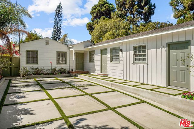 1334 San Vicente Boulevard Santa Monica, California Excellent move-in condition, single-level home with easy stairless access. Over 2,400 sqft, this charming 3-bedroom, 3.5 bath home is set high above the street on a large corner lot offering privacy rarely found North of Montana. Large windows fill the home with vistas of lush greenery & ocean breezes, while a central courtyard provides the ideal setting for indoor/outdoor living. Spacious living room with fireplace and lovely windows bring in the afternoon light while allowing privacy. A generous dining room opens to the courtyard. Renovated chefs kitchen with center island, stainless steel appliances, great pantry space & a bay window with pretty garden & treetop views. Large & inviting family room. The primary bedroom is newly renovated & has a private gym/office with direct access outside & a luxurious new bathroom with white marble counter & rain shower. The junior suite also features a beautiful brand-new bath. The enormous brick courtyard is surrounded by lovely landscaping & mature trees, the perfect place for dining & entertaining outdoors. The elevated, grassy, front yard is a lovely place to enjoy the sunset or morning cup of coffee. Wheelchair accessibility and stair-free direct access. Move-in ready & exceptional value!