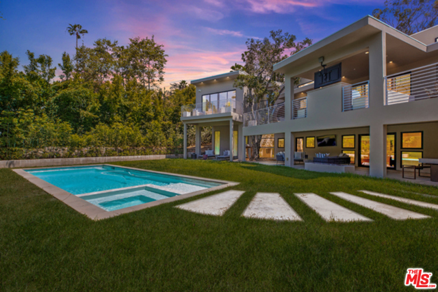 1085 Carolyn Way Beverly Hills, California Sophisticated and thoughtfully re-imagined (2016) contemporary smart home situated just north of Sunset on legendary Carolyn Drive delivers the perfect synergy of warmth and design brilliance. Light-filled living spaces, and sliding walls of glass flow effortlessly onto outdoor living spaces and true SoCal living. The open concept living space features wide oak plank floors, 12 foot ceilings, Fleetwood doors and clerestory windows, an open entertainer's kitchen with Miele professional appliances overlooking the spacious outdoor living room. Retreat to the private MBR suite with spa inspired bath area and spacious custom closet area. The lower level features 3 ensuite bedrooms,gathering area, and inviting media room that envelops a lush completely private outdoor sanctuary with covered entertainment area, sparkling pool and spa. Just a few short minutes north of Sunset, restaurants, shopping and the ultimate California lifestyle. Also available for Lease- call agent for rate and terms