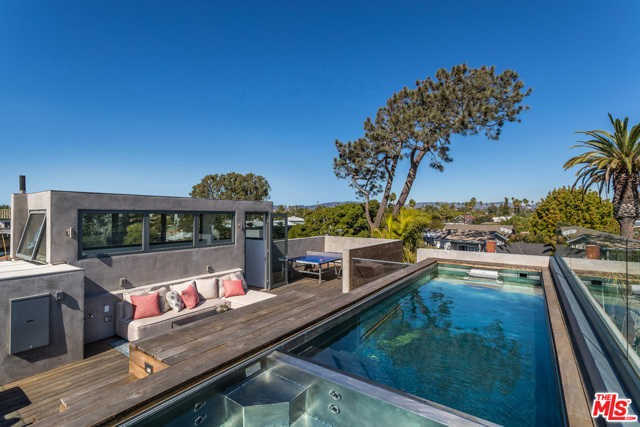 1647 CRESCENT Place Venice, California The premiere walk street in Venice boasts a TRUE architectural jewel. Designed and built by David Hertz, FAIA, this home was impeccably crafted using only the finest materials and finishes. Walls of glass open on 3 sides of the grand main floor, inviting the ocean breezes in & joining the open living & dining rooms to the lushly landscaped garden beyond. The perfectly appointed kitchen has bespoke walnut cabinetry, integrated appliances & a touch of marble. Upstairs the master suite unfolds w/ a second lofted living room opening onto the private "tree house" deck with blue sky and mountain views. The sunlit master bath is found as you pass through the custom walk in closet. 2 separate guest rooms, jack-n-jill bathroom, & flex space for home office, TV room or your Peloton complete 2nd floor. The jewel in the crown is the rooftop deck with panoramic views and the ROOFTOP POOL w/ spa & endless current generator. This home offers it all - elegance, design, privacy and comfort.