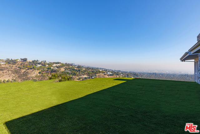 10111 Angelo View Drive Beverly Hills, California An ultra-private retreat on a quiet cul-de-sac in lower BHPO, this contemporary residence captures sweeping views to Downtown L.A. This is an incredible opportunity to remodel and add significant square footage or completely reimagine the half-acre homesite. Filled with natural light from skylights and floor-to-ceiling windows throughout, the homes beautifully scaled living spaces are warmed by wood tones and natural stone accents. The spacious foyer leads to an open-plan living, dining, and family rooms, featuring a wet bar and stone fireplace. Glass doors open to the expansive pool terrace. The upgraded kitchen features a breakfast bar and alfresco dining. Features include an upper-level terrace with views across the city and a 2-car garage. Offering endless possibilities on a half-acre in prime BHPO, located moments from Beverly Hills best shopping, dining, entertainment, and next door to one of the most prestigious estates in the city with an approx. value up to $150,000,000.