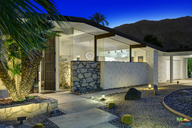 2455 S Via Lazo Palm Springs, California Rare South facing Mid century modern home on the beautiful Indian Canyons golf course in South Palm Springs. Light and bright this four bedroom and five bathroom nearly 4,000 Sq/Ft home is the perfect primary residence, second home, or investment property. Dramatic custom wood doors open to a light filled foyer with a stone wall and plants. The main living area has living, dining, fireplace, and a wet bar that are perfect for entertaining. Views to from the main living area to the sparkling pool, golf course and San Jacinto Mountains. Separate attached den for television or relaxation. Four bedrooms with great separation. The primary bedroom has two ensuite bathrooms for ultimate privacy and a sitting area with a gas fireplace. Large updated kitchen and eating area with beautiful views. The perfect home to enjoy the desert lifestyle and all that Palm Springs has to offer.