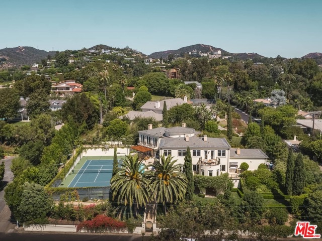 701 N Bonhill Road Los Angeles, California Gated and private contemporary Mediterranean masterpiece on one of the best streets in Brentwood. One of the few tennis court estates on the Westside. The sprawling 2/3 acre lot also is inclusive of park like grounds, gardens and pool. Past the gate and motor court walk through the front door into the grand foyer with soaring 20 foot ceilings. First floor has chef's kitchen, formal dining, formal living room and study. Continue up the spiral staircase where you are immediately struck by walls of glass that look out over stunning treetop and ocean views. Top floor has spacious master suite, oversized office and 2 additional ensuite bedrooms. Another spiral staircase brings you to basement level which has gym with sauna, another ensuite bedroom, and media room seamlessly leading out to tennis court. Every aspect of the home was custom built with an eye towards entertaining and utilizing California's indoor/outdoor lifestyle.