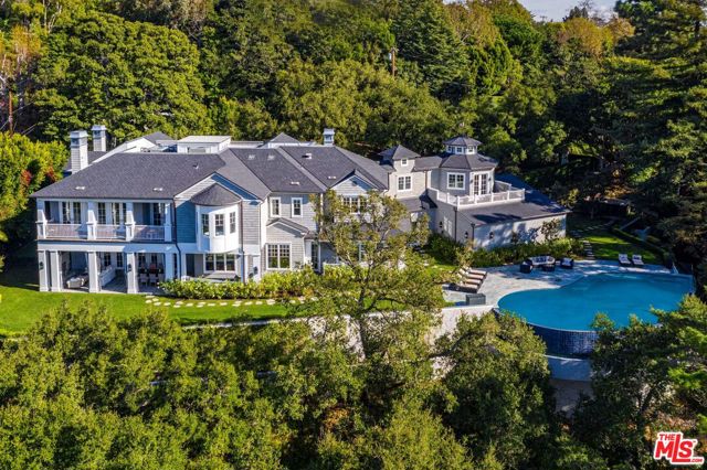 940 E Oakmont Drive Los Angeles, California Situated in lower Mandeville on a vast acre plus lot with utmost privacy, The Oakmont Estate is a magnificent Hamptons style home with world-class views in one of the city's most desired communities, Mandeville Canyon. Penned by Philip Vertoch and brought to life by Gordon Gibson, this spectacular dwelling is situated on gorgeous park-like grounds with a putting green, alfresco dining area with a kitchen and multiple entertaining lawns. An infinity pool and spa overlook the much coveted, lush and verdant canyon views providing an idyllic escape. Built with unrivaled sophistication from the finest materials worldwide, it boasts top-of-the-line amenities such as a sizable wine cellar, full bar, a home theater, and a gym. Minutes away from Sunset Blvd. and optimized to be a smart home, this heavenly retreat is a perfect blend of old-world grandeur and modern convenience. This architecturally significant work-of-art will be the pride and joy of generations to come.