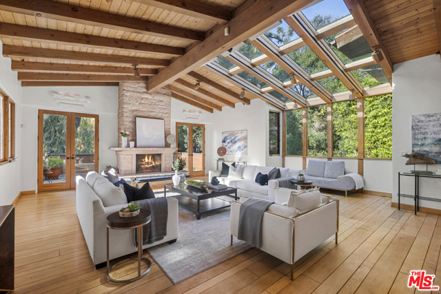 2770 Hutton Drive Beverly Hills, California Serenity in the city. Sitting high above the street up a gated driveway on a quiet & beautiful tree lined street in the Estates section of Old Hutton, just minutes from the heart of the city. This 5 bed + 5.5 bath celebrity retreat on almost half an acre boasts character & detail throughout. Soaring high vaulted beamed ceilings & huge custom skylights, large picture windows drench each spacious room w/natural light. Home gym, guest quarters & library. Upstairs, the spacious main suite w/elevated ceilings, 2 walk-in closets & tranquil bath w/Japanese teak soaking tub looking out to a large zen garden wall fountain. The outdoor grounds provide plentiful gardens w/a lush hillside orchard, large solar-heated pool, hot tub & deck, koi pond, grass pad & sports court. This one-of-a-kind property is a tucked away private oasis just moments from the heart of Beverly Hills & the great restaurants & shops at the Glen Centre, in coveted Warner Avenue Elementary.
