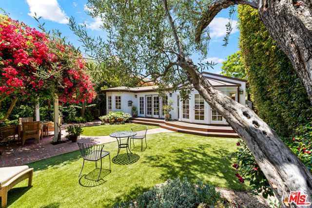 817 22Nd Street Santa Monica, California A one-of-a-kind, completely private garden oasis in the 90403 zip code, just south of Montana within walking distance of Franklin Elementary School. This is the perfect one-story home for a family as well as for those looking to downsize. The living room, filled with natural light, is double the size that one would expect. There are seven skylights between the main house and the lovely detached studio/workspace (with bath) that opens onto the park-like, impeccably landscaped, storybook backyard. The guesthouse is not included in 2,108 square footage. The house has 3 bedrooms 3.5 bathrooms. The master suite has a vaulted ceiling and gorgeous bathroom with a tub overlooking flowering bougainvillea, climbing baby roses, wisteria, and hummingbirds that come to drink at the fountain. A recently remodeled kitchen with granite countertops opens onto the family room. Central air and heating throughout, fully alarmed, newly refinished hardwood floors, dining room. This house is a rare find.