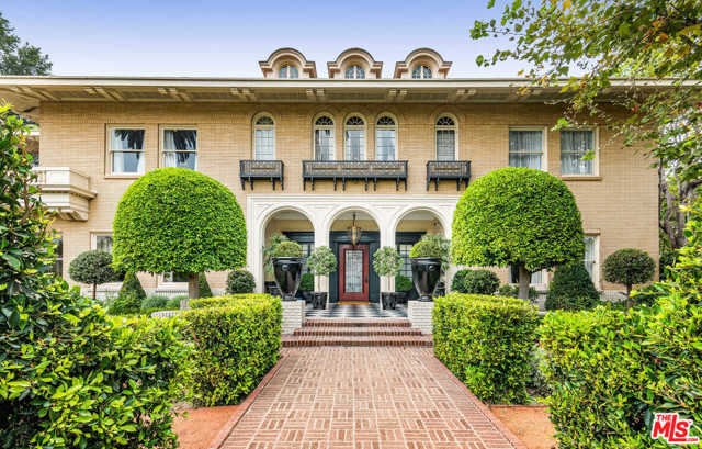 601 S Windsor Boulevard Los Angeles, California Originally designed by architectural icons Hunt & Burns in 1914, this stunningly restored, historic estate is a gateway back in time. Seamless blending period details and modern amenities, the interiors evoke the glamour and prestige of the roaring 20s and Great Gatsby. The 2-story entry showcases handcrafted details, wainscotting, tray ceilings, and elaborate moldings. Formal living and dining rooms flank the entry, while the chef's kitchen boasts custom finishes and marble countertops. 9 bedrooms include the elegant master suite, with separate spa-like baths, custom closets, and a private terrace. Journey downstairs to find a speakeasy, cigar lounge, home theater, and gym. Separate guest house, manicured grounds, herb gardens, alfresco dining terrace with caf lights, outdoor kitchen, pool, spa, and poolside cabana with fireplace round out the property. Offering absolute privacy among majestic gardens and mature trees, this Hancock Park estate is unlike anything else you've ever seen.