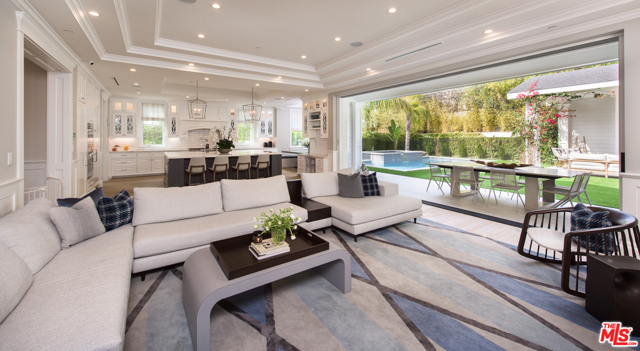 9615 Bolton Road Los Angeles, California Located in the heart of Beverlywood, this reimagined Traditional estate by famed designer Lonni Paul checks off every detail from even the most selective of buyers. Immersed with natural light as you enter, a grand 2-story living area opening out to an outdoor patio. A custom milled formal dining room envelopes you with coved ceilings and hand woven wallpaper that sets the tone for a palette of finishes that pleases a true critiques eye. An open floor plan leads to a chef's kitchen with an oversized island, butlers pantry, and eat-in breakfast area. The family room includes retractable doors opening to the gorgeous backyard with pool/ spa and a cabana with fireplace. Upstairs there are 3 en-suite bedrooms and a private master suite with custom closets and a spa-like master bath. The lower level includes a large scale entertainment zone with custom home theatre, substantial modern gym, a chilled 1000-bottle wine cellar, and an additional guest suite with views of the outdoor patio.