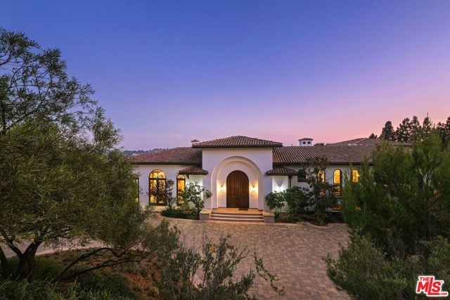 13870 Mulholland Drive Beverly Hills, California Modern Spanish Estate perched atop an acre of lush park-like grounds with expansive and stunning views from nearly every room. Located on the famous Mulholland Corridor this architectural masterpiece offers 6 beds, 9 baths and is the ultimate in luxury, elegance, and design. Enter the formal foyer to exquisite and impressive details include grand crown molding, 16ft vaulted ceilings, and dramatic high arched walkways into the two large public rooms which include 2 marble fireplaces and custom cut stone flooring. The chef's kitchen includes Sub-Zero & Miele appliances and gorgeous built-ins. From there follow the elegant staircase to the 4 upstairs en-suite bedrooms including an impressive master suite with a jet tub, his and hers walk-in closets, and a minibar. Below find a media room, guest room, game room, office, and wine cellar. Manicured gardens with a pool, spa, waterfall, cabana, sports court invite you to enjoy the outdoors. Gated motor court provides room for over 25 cars.