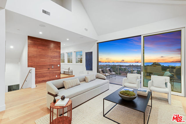 1324 Monument Street Pacific Palisades, California Modern Nantucket With Panoramic Ocean & City Views Including The Palisades Village. Newly Constructed and finished in 2021, this bright & airy home offers an open floor plan on the main floor that has ocean breezes flowing in through the living area and to the pool & yard . Kitchen with high end appliances including Gaggenau, Miele & Sub-Zero, large Cristallo Noir stone above cooktop & Cristallo Quartz counters on center island. Living room with a large fireplace & spacious patio opens to the ocean & city views. Main floor includes an office/guest suite. 2nd floor offers an Elegant Master Suite with fireplace & sitting area that opens to city lights & ocean views. Zenful master bath has natural wood elements complementing Calacatta Gold Marble vanity & beautiful stone work. Two additional private suites on 2nd floor. A substantial great room on the 3rd floor is ideal for a home theatre, play room and a home gym. Private pool & spa off grassy backyard & roof deck with sweeping views.