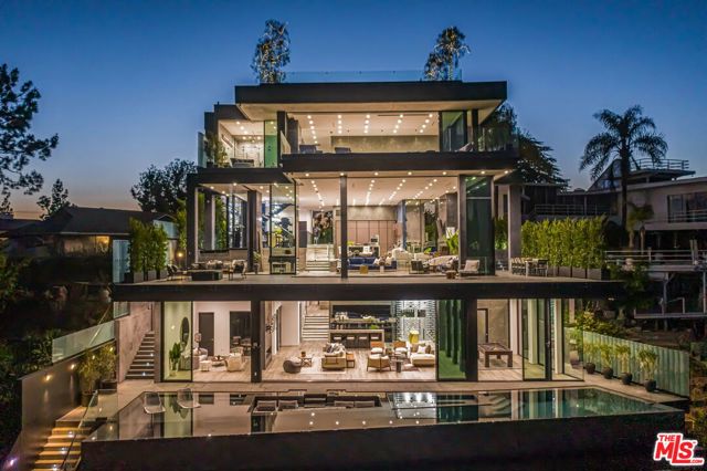 2304 Donella Circle Los Angeles, California Rare opportunity for an impeccably crafted modern Bel Air masterpiece w/the best Los Angeles views, hand-selected materials from around the globe, lux finishes and disappearing walls of glass showcasing jaw-dropping lake, city and mountain vistas. Enormous open main floor w/soaring ceilings, elegant custom Italian designed kitchen, dining, decks, outdoor dining, fire pit and BBQ. Spacious & sumptuous master w/mesmerizing views, sun-soaked decks, walk-in closets and decadent bath w/exotic Spanish tiles, steam shower, soaker tub, dual stone sinks and double sided fireplace. Amenities: oversized lower entertainment space, 1000+ walk-in wine cellar, gym, 4 level elevator, gated driveway, 5 car garage, Sonos sound system, LED lights, crystal chandeliers, white oak floors and more. Estate affords endless outdoor living enveloped by the views, w/70ft infinity pool w/spa, approx. 3000sf grassy yard w/exotic wood deck, approx. 2000sf roof w/firepits, kitchen & solarium w/serene water feature.