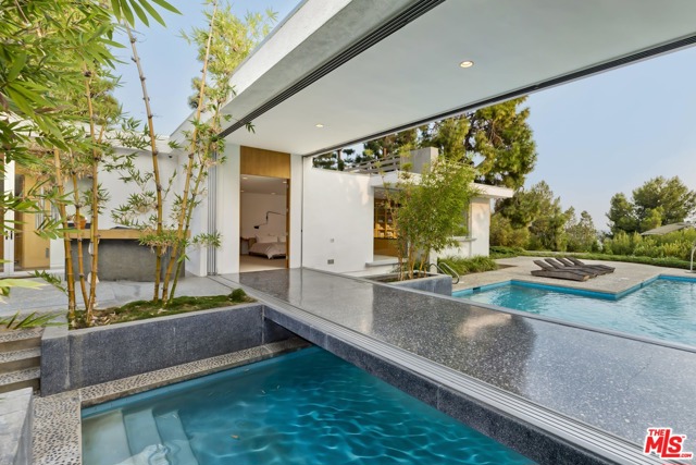 1163 Calle Vista Drive Beverly Hills, California Holt House by Hal Levitt. World renowned mid-century architecture, nestled within Beverly Hills' most prestigious private enclave. Featured in numerous publications and recognized as one of the most important modern homes of Southern California. Magnificent museum-quality with impeccable craftsmanship throughout. Behind gates, at the end of a long private driveway. The entertainment areas are built around the courtyard which creates indoor/outdoor enjoyment with lofty ceilings, fully glazed walls, and dark terrazzo floors. A fascinating bridge is perched over the lavish pool connecting the private wing of the house with the living room. Gorgeous gardens surrounded by mature trees, rooftop deck, a detached guest house, all with utmost privacy.