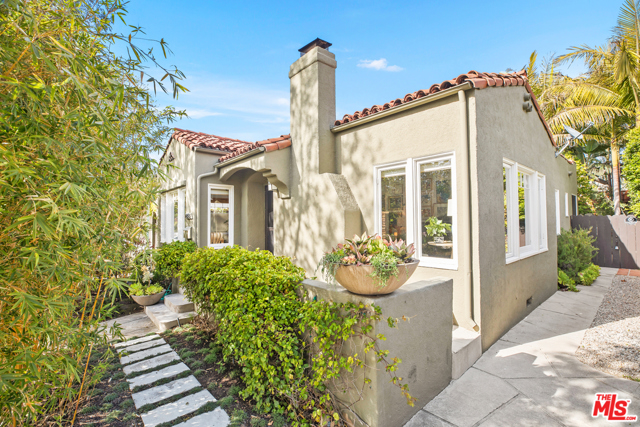 2818 Grayson Avenue Venice, California One of the first houses built in the area, this charming Venice bungalow is the ultimate Westside retreat. Step into this serene single-level home decorated by Johnson Hartig of Libertine, rich in character and tastefully finished with coved ceilings, white hardwood & tile floors throughout. A large stacked stone fireplace warms up the living room, connecting you to the formal dining room and kitchen. Glass doors in the primary and second bedrooms lead you to a private, lush outdoor oasis designed by landscape visionary Jay Griffith, featuring mature trees, a beautiful koi pond, and a treehouse. Perfect for entertaining or your best-kept secret, the backyard surrounds you with peaceful beauty, and includes a large deck w/ fire pit, and detached studio/office with fireplace.