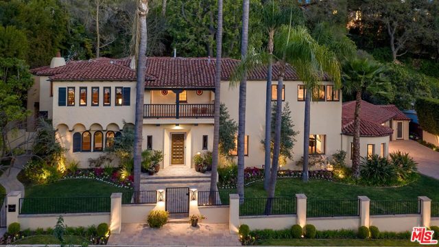 1130 Tower Road Beverly Hills, California Featuring stately curb appeal in the flat section of coveted Tower Road just north of Sunset, this grand gated Spanish estate is infused with period details; but, updated for one's modern sensibilities. Sunlit rooms with high beamed ceilings, wood and tile floors, two upstairs balconies, French doors, authentic hardware, and stained glass. Dramatic 2sty entry foyer sets the tone. Massive living room with impressive fireplace and adjacent circular den/sun room. Gracious dining and breakfast rooms. Chef's center-isle kitchen combines with a huge comfortable family room for superb entertaining capacity. 4 generously-sized bedrooms upstairs (one is a large convertible library) and a quaint outdoor guest suite/gym. Separate powder room and a downstairs guest bathroom. Mammoth master suite with peek-a-boo city lights treetop views, office area, dual walk-ins, and inviting bathroom. Living, breakfast, and family rooms all open to glorious patios, lawns, and meditative hillside gardens. 3 car direct-entry garage for privacy and security along with great off-street parking. A Tesla Powerwall and vehicle charger are of added benefit to an already tremendous home of which one can be proud to call their own.