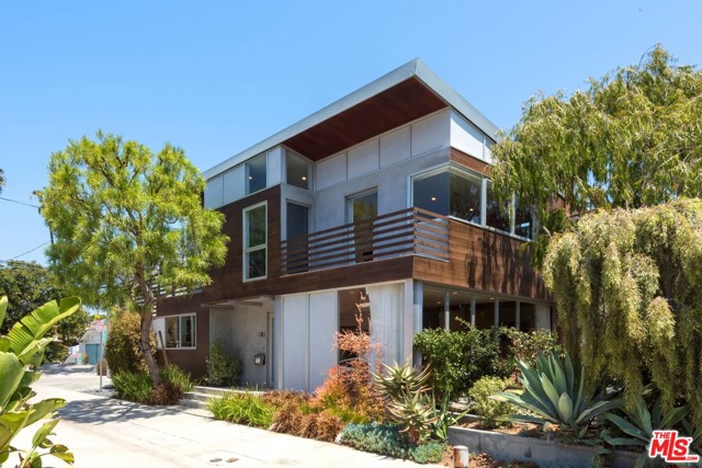 211 SHERMAN CANAL Venice, California Dramatic 2-story modern architectural with 3 bedrooms, 2.5 bathrooms and a separate detached studio suite with open living area, bath and rooftop deck. Sought-after spacious corner lot in prime canal location near bridge and complete with boat landing. The open floor plan includes a well-appointed kitchen with breakfast bar and dining area adjacent to a large family room with fireplace. The common area flows directly through floor-to-ceiling Nana doors to a lush patio overlooking the canal. The upper level features two bedrooms and two bathrooms, laundry service, and a gracious primary suite with walk-in closet, an elegant bath and a private balcony with fabulous canal views. 4 car parking includes a two car attached garage plus 2 additional spaces. Conveniently located near the beach and local shops and restaurants on Abbot Kinney and Rose Avenue. The best that Venice has to offer!