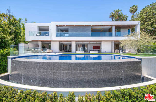 1401 Londonderry Place Los Angeles, California Capturing sweeping views of the L.A. city lights, this new modern architectural is tucked among the trees on an ultra-private promontory above the Sunset Strip. Envisioned by architect George Kurczyn the residence embodies Californias indoor-outdoor lifestyle while featuring a thoughtful blend of intimate areas and voluminous entertaining spaces. Enter the gated, tree-lined drive to the soaring 2-story entry and spectacular living/dining areas, where Fleetwood doors reveal the views and open to the infinity-edged pool. The primary suite boasts a sitting area with fireplace, private balcony, dual dressing rooms and spa-style baths. Features include a family room, office, library, show kitchen with Miele appliances, catering kitchen, 12-seat theater with 20 screen, a 1,2000-bottle collectors wine cellar, gym, 3-story elevator, Crestron automation and 4-car garage. The 11,300-sq-ft home offers the utmost peace and quiet, moments from the citys best dining, shopping and entertainment.