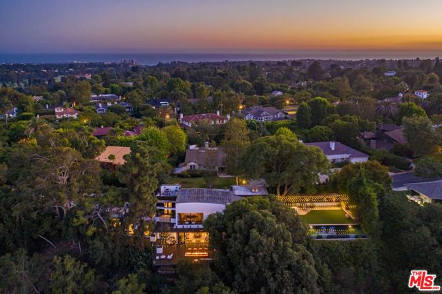 1514 San Remo Drive Pacific Palisades, California Set in the tranquil, rolling hills of the Pacific Palisades Riviera and just minutes away from world class shopping, dining and entertainment in Brentwood, Santa Monica & the Palisades Village. This architectural marvel is a one of a kind luxury estate complete with picturesque views of the Brentwood Hills out to the Getty Center. An outdoor haven with perfectly proportioned infinity pool & spa, oversized lawn with lush landscaping and generous entertainment deck space. Gracefully appointed and understated interiors include top of the line finishes and appliances throughout. This magnificent estate offers 5 bedrooms and 7 baths, an open kitchen, family room, den, formal dining room, screening room, master office, staff office, and a large great room leading to an oversized terrace with a fire pit overlooking the canyon. This is luxury living and simplistic sophistication at its finest.