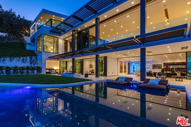 9364 Beverly Crest Drive Beverly Hills, California Eclipse Beverly Hills. Triumphant modernism meets Art Deco jewel box to create a most special Eclipse. A culmination of 5+ years of design and construction, this gem encompasses over 10,270sqft with jetliner views from the city to the ocean. Upon arrival large gates, reveal massive motor court that can accommodate approx. 15 cars and security suite. Descend the most dramatic entrance in the city with a skylit elliptical staircase floating over a waterfall and pond. A Showstopper in every way, the great room offers 14ft ceilings and walls of automated glass that retract to the view. Designed for entertaining with full show kitchen and back catering kitchen. Primary bedroom is the ultimate Deco Fantasy with walls paneled in Macassar and velvet, lavish double baths and closets. Lower level offers a game room and bar, screening room, gym and 3 additional bedrooms suites. 92ft long infinity edge pool, curves before a vast lawn and gardens. Eclipse is and will always be a Beverly Hills legen