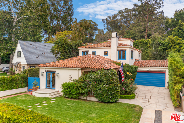 738 San Lorenzo Street Santa Monica, California On desirable San Lorenzo Street, where the road widens and the neighborhood quiets, you'll find this quintessential Santa Monica Canyon home, exuding charm from each of the original 1927 Spanish details, while offering all of the modern necessities of today. Tall hedges create a large, private, grassy front yard, ideal for relaxing, picnicking, or playing catch. The front porch is masked by roses and peach trees, making a romantic entry. Enter the living room, fitted with a smooth stucco fireplace, tall windows, and wood ceiling. Each room naturally flows to the next, with the dining room opening to the front yard, breakfast nook, and then to the kitchen. The kitchen is the heart of the home - the use of bright colors and textures makes it both aesthetically pleasing and joy-producing. Downstairs also features two large bedrooms and the family room, which opens to the backyard. The yard is large enough for a pool and is ideal for family, games, and entertaining. Upstairs includes one secondary bedroom, plus the primary suite, which offers views of the blooming jacaranda trees, tons of natural light, and a separate space, perfect for an office or sitting room. Enjoy every inch of this unique home and fall in love with the neighborhood, moments from the beach, Canyon Charter Elementary school, shops, and restaurants.