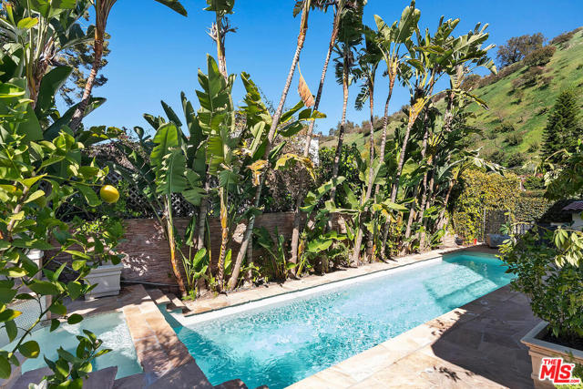 1501 N Beverly Drive Beverly Hills, California Recently renovated and impeccable 4 +4 contemporary Spanish just 5 minutes from the Beverly Hills Hotel. Gourmet Chef's kitchen includes Thermador range and ovens, Sub-Zero refrigerator and outdoor breakfast area off of the kitchen. The downstairs bedroom, kitchen, dining, and family rooms all open up to beautifully manicured and serene outdoor living and entertaining spaces, all completely private. The luxurious and massive master suite features vaulted, exposed beam ceilings, 2 large sitting areas, private deck, 2 walk-in closets and bathroom with steam shower and sauna. The lush tropical landscape surrounds the newly resurfaced salt water pool, built-in natural gas BBQ with pizza oven, multiple seating and dining areas, and new top-of-the-line golf practice area with 4 hole putting green and hitting net. Additionally, garage has been converted into a bonus room/gym with full bath and private entrance. Coveted Warner Ave Elementary school district. Walking distance to Coldwater Canyon Park, Beverly Hills jogging track and Franklin Canyon hiking trails.