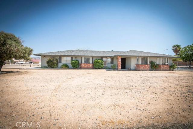 18079 Dunkirk Street Hesperia, California Stop the car... This home wont last long. Located in the desired area of Hesperia known as The Mesa. This single level home features 3 bedrooms, 2 baths, 2000 square feet of living space and is situated on just under a half an acre with side RV gate that can accommodate your RV/recreational toys. As you enter this beautiful home, you are greeted by the large formal living and dining room. Enjoy the modern gray tones with white trim through out the home as you enter into the spacious family room with a large brick fireplace, perfect for those cozy nights. The family room flows into a large kitchen with plenty of cabinet space, granite countertops and a large peninsula, perfect for entertaining. Spacious pantry is located in the adjacent laundry room with plenty of storage. You cant miss the beautiful dark laminate flooring that runs throughout the common areas of the home and is toped off with carpet in the bedrooms. This home boasts two spacious guest bedrooms and a large master bedroom. Wonderful built-ins grace the hallway and reading nooks under each guest bedroom window ad lovely charm to this home. The backyard is an open canvas with a covered patio and has endless possibilities (ex. possible pool, kids playhouse, outdoor dining/entertaining area). Don't miss out, schedule a showing today.