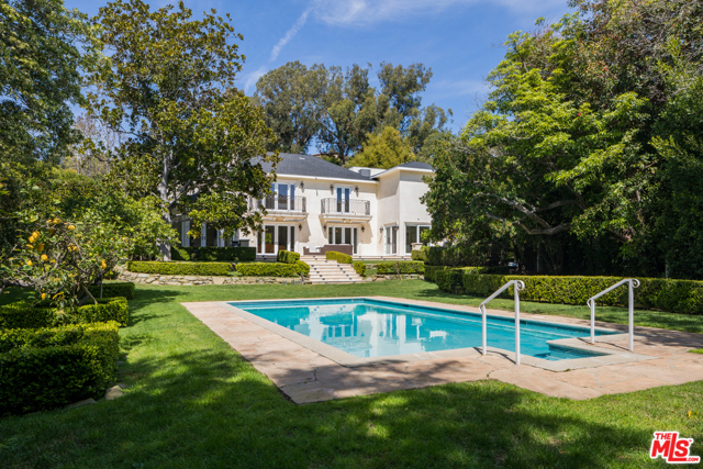 10914 Bellagio Road Los Angeles, California Where Old Hollywood Glamour and Contemporary Traditional meet. Tucked away in prime Lower Bel-Air, this private and gated residence sits on nearly 20,000 sqft. Enter the 4-bed, 5-bath estate through double glass and iron doors into the formal two-story foyer with grand staircase. The chef's kitchen is the heart of the home with a large center island, ample cabinetry, state-of-the-art appliances, and a breakfast nook with access to the outdoor dining patio. With dark cherry hardwood floors and natural light throughout, the living room, family room, parlor, and formal dining room include French doors that open onto the backyard. Impeccably manicured, the sprawling lawns are replete with an expansive patio, sparkling pool, alfresco dining, grassy spaces, verdant trees and landscaping. The 2nd level consists of two guest bedrooms, large den with balcony, and a private master retreat with balcony, dual walk-in closets, and a spa-like bath. Quintessential California living at your fingertips.