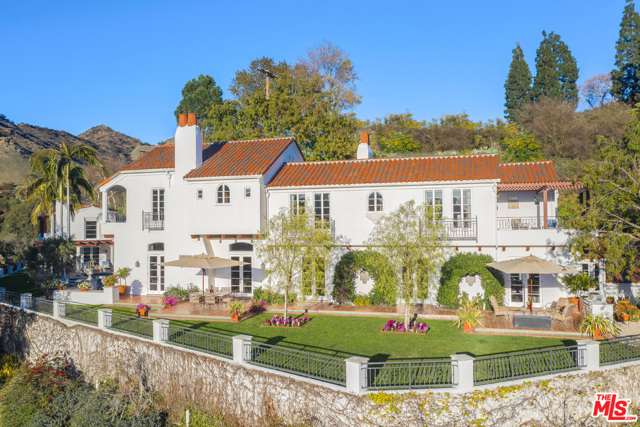2568 Park Oak Drive Los Angeles, California Enter the gates and ascend the 280-foot driveway to this dazzling Spanish hilltop estate designed and built by legendary architect Ed Fickett. The 4BR/4.5BA residence sits atop the .9 acre property; one of the largest and most private parcels in the coveted Oaks. Pass through a monumental pair of antique front doors and the enter the 22-foot-high foyer leading to the main home's 5,264 sq.ft. interiors. The compound also provides room for visitors with its 2-story guest residence and hotel-style spa, with marbled steam room, dry sauna, whirlpool tub, and massage areas. The 1BR/1.5BA guest house's 1,177 sq.ft. of additional living space was designed by award-winning architect, Anthony Stark. Hollywood glamour abounds around the pool, which is completely lined with cobalt mosaic tile. Gaze at unparalleled canyon views--including famed Griffith Park--while the sun shines on this never-marketed crown jewel of Los Feliz; enjoyed by its original owners for over 30 years. Additional property features include: 1,000 sq.ft. master suite with loft/office and private terrace, all guest rooms en-suite, chef's kitchen with island, breakfast bar, and newer appliances, library/office with wet bar, five fireplaces, 6 HVAC systems (10 zones), extensive terra cotta walkways and patios, 2 expansive lawns, on-site event parking, alarmed, gated, fenced, 600-amps of power.