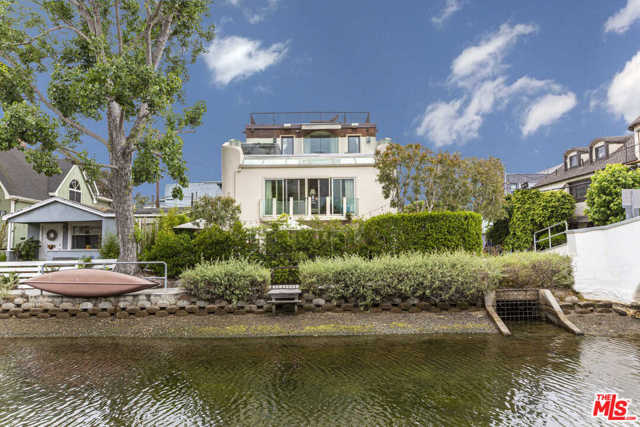 241 CARROLL CANAL Venice, California Rare Venice Canal find with 5 bedrooms and parking for 6 cars, comes this charming contemporary set on one of the largest corner lots with fantastic views. Soak in the spectacular canal-front patio with built-in bar, bbq and firepit that opens to a large living area perfect for entertaining guests. The ground floor is rounded out with two bedrooms and one full bathroom. Entering through the main entrance on the second floor, youll discover the large open concept space boasting high ceilings defined perfectly for living, dining and cooking while taking in the canal views through masterful floor-to-ceiling glass French doors. Down the hallway enter one of two sizable bedrooms, which share a large bathroom. On the third level, retire in the master suite with huge balcony, spectacular views and hot tub. Tons of closet space and luxurious spa inspired bath complete this stunning master retreat. Finally, bask in an impressive rooftop deck space with 360 views capturing the essence of Venice