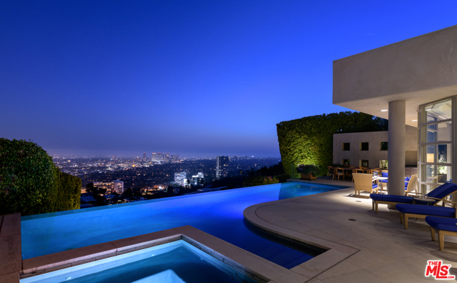 9000 Thrasher Avenue Los Angeles, California Nestled on the 'Front Row' of the highly coveted Bird Streets sits this architectural marvel boasting unrivaled views from Downtown to the Ocean. Private and securely set off the street behind gates, this gorgeous estate leads you to the front door through a serene path accented by beautiful greenery, fire features, and a tranquil koi pond. The main living highlights the explosive vistas like a work of art through floor-to-ceiling windows and sliding glass doors allowing for beloved indoor/outdoor California living. From sunrise to sunset, entertain or unwind in the jaw-dropping multi-level yard with a sparkling infinity edge pool, spa, patio space for al fresco dining and lower level built-in seating with fire pit. Gourmet chefs kitchen features Miele appliances, Wolf range, island, extensive cabinetry, & breakfast nook. Feel as if you are in a 5-star resort in the spacious & sumptuous master w/fireplace, sliding glass doors for direct yard access, boutique worthy walk-in closet & spa-like bath. Amenities include well-appointed guest suites, media room, lavish formal dining room, Poggenpol kitchen, staff quarters, 455 bottle wine cellar, lower-level fitness studio w/bath, 2-car garage w/driveway parking, & much more. This lux oasis in the sky feels like a secluded paradise, but is just moments from the best of WeHo & Beverly Hills!