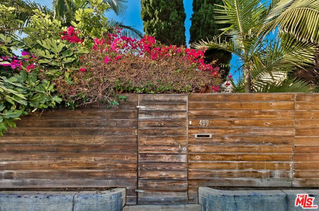 409 WESTMINSTER Avenue Venice, California Steps from Abbott Kinney walk through gates and find this gated private beach house. With white painted wood floors, the cooks kitchen, living and dining room all open to each other for a casual lifestyle. The living room offers a wood burning fireplace and built in seating overlooking the enclosed front grassy yard. A separate sitting/TV area with more built in seating opens off of the living room. There are 2 bedrooms on the main floor, one with an ensuite bathroom. A huge bonus room upstairs that can be used as a big bedroom, office, family room or whatever fits your needs. A large private fenced and gated back yard with fruit trees and room for a pool or to build what you need. Plenty of parking.