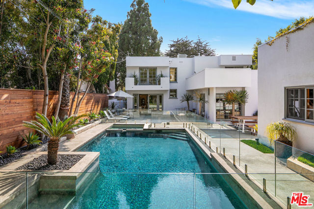 621 15Th Street Santa Monica, California Private and rare architectural jewel with spacious yard and swimmers pool located just North of Montana in the heart of Santa Monica. This updated 3,100 sf contemporary 4 bedroom + 3.5 bathroom home is hidden behind mature hedges and landscaping with a large front yard. Enter into the spacious living room with an imported antique French wood-burning fireplace that flows directly into the dining room outfitted with a beautiful Art Deco chandelier. The home showcases new hardwood floors, an abundance of light, and flawless flow from each room to the next. The custom chef's kitchen with top-of-the-line appliances opens to the breakfast room and family area with French doors flowing to the very large and lush backyard featuring a pool and jacuzzi, entertaining area and outdoor dining located next to the 1,200 bottle wine room and gym. The spacious Master Suite offers an exceptional spa-like custom marble bathroom including a steam shower and large walk-in closet. 3 additional generous sized guest rooms are located upstairs. Truly a Santa Monica masterpiece!