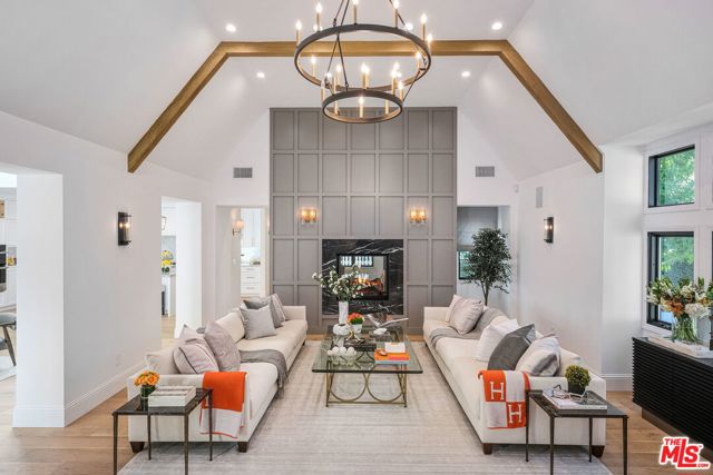 604 N Palm Drive Beverly Hills, California A dramatic entry sets the tone for this open floor plan with white oak flooring & high ceilings. The beautiful craftsmanship and attention to detail are found throughout the property starting with the dramatic 2 story living room showcasing a custom double-sided marble fireplace with stylish woodwork opening into the chic dining room with shiplap walls and soaring ceilings. State-of-the-art appliances in the Gourmet kitchen include Subzero fridge, Wolf stove and spacious butler's pantry complete with second refrigerator and dishwasher are surrounded by dramatic glass doors that seamlessly open to manicured grounds which include a sparkling new pool and custom-built BBQ area ideal for entertaining. Other features include a spacious master suite with large walk-in closet & marble bathroom, 4 additional bedrooms and 2 powder rooms. All systems are brand new including electrical, plumbing, HVAC, windows, roof and Cat 6 wired for alarms, 10 security cameras and Smart Home Technology.