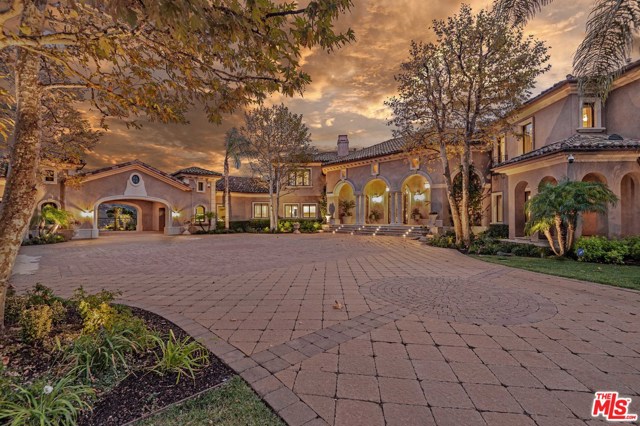 13792 PACIFIC BREEZE Drive Camarillo, California Situated on a knoll at the end of a gated enclave, it is rare to find an estate of this measure. Constructed with privacy and comfort in mind, this approx 13,000 SqFt home features a grand entrance, beautiful views, high ceilings, and an open floor plan. Everything opens up to the over two acres of land accompanied by a waterfall, pool, spa, multiple gardens, fountains, and lush lawns - giving this property a resort feel. One entire level is dedicated to entertainment - consisting of a lounge, theater, wine cellar, gym and bar. The ground floor master suite is a complete retreat with a luxurious bathroom and the additional four bedrooms are all ensuite. Additional features include two kitchens, a dog wash, and heated floors. When it comes to parking, the 5 garage spaces + additional outdoor covered spaces add up to roughly 16 spots in total. This property has it all. The epitome of comfort and opulence.