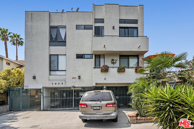 1605 Winona Boulevard 201 Los Angeles, California 2-bedroom 2 bath Top Floor Street-Facing unit in an intimate 8-unit condo building in Hollywood. Best unit in the building! Extra-High ceiling height in the living room and views of Hollywood and Griffith Observatory! Up a short flight of stairs, the main entrance has a security door. A large living room and dining room opens up when you come inside to floor to ceiling windows and plenty of natural light. Ceiling fan in the living room. Efficient Galley Kitchen has raised panel traditional cabinets, Formica counters, and fridge, stove, dishwasher, and microwave. Laminate hardwood flooring throughout. A nice size balcony off the living room has the views. Both bedrooms are good size with their own bathrooms. Central HVAC. Unit comes with two parking spaces in gated garage. Community Laundry.