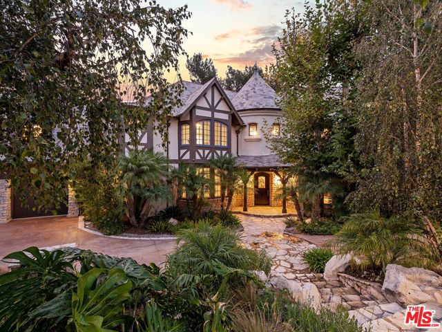17628 Camino De Yatasto Pacific Palisades, California Located in the exclusive Palisades Country Estates, this 24-hour guard-gated community is only minutes from the Palisades Village or Santa Monica. This beautifully detailed 2-story Country English estate with approximately 6,711sf is set amongst the trees and offers 5 bedrooms and 6.5 bathrooms. With vaulted beamed ceilings throughout the home, the family room offers a full wet bar and a large fireplace. French doors lead to a backyard and pool area ideal for entertaining. Near a remodeled kitchen are a spacious dining room, butlers pantry, wine room, and breakfast room. The kitchen also includes a center island, top-of-the-line appliances, 2 dishwashers, and a wine refrigerator. The primary suite with a large bathroom includes a fireplace, separate sitting area, and balcony. The other 3 bedrooms upstairs are all en suite. A very large upstairs room with a 3/4 bath can be used as a game room, gymnasium, or for additional sleeping quarters. There is a maid's quarters with a separate entrance. A private backyard includes a large built-in BBQ, fenced pool and spa, and flat play area. Also included is a large 3 car garage. Lush landscaping, and close to hiking trails in the Santa Monica Mountains.