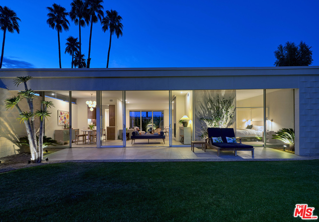 320 Desert Lakes Drive Palm Springs, California A stunning renovation of a mid-century classic at the sought after Seven Lakes Country Club. Originally designed by architect Richard Harrison in the late 60's, this recently renovated home boasts 10 foot tall floor-to-ceiling walls of glass, clerestory windows, a private patio & inspiring South facing mountain views. The home features new Italian porcelain floors throughout, gas burning fireplace, automated blinds in the living rm & an automated projection screen for movie nights. The chic kitchen features custom walnut cabinetry, quartz countertops, stainless KitchenAid appliances, wine fridge, farm sink & hand glazed tile backsplash. The smart range & faucet are both Alexa compatible. The large primary suite features walnut built-ins & a spa-like ensuite bath with Room & Board vanity. Additional features of the home include a new tankless water heater, washer/dryer inside, generous closet space & a single carport. There is also ample guest parking & easy pool access. Seven Lakes is a private golf community located by the Parker Hotel in South Palm Springs. With 24/7 gate guarded entry, amenities include a Ted Robinson designed 18 hole golf course, pro lessons, practice putting greens, 15 pools/spas (most with cabanas & grills), tennis court, William Cody designed clubhouse w/ dining rm, lively bar/lounge & outside terrace patio & mature landscaping.