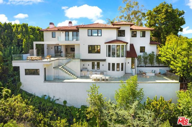 1280 Angelo Drive Beverly Hills, California This gated Architectural masterpiece is nestled among distinguished estates in the view corridor of Upper Angelo. Quite simply, this is a one-of-a-kind property with breathtaking unobstructed panoramic city and ocean views. This home is an entertainer's delight and beckons you to linger on the patio areas and enjoy an evening glass of wine. Downtown Los Angeles, the ocean, city lights and stunning sunsets are all visible from every outdoor area and nearly every room, as the home is designed to maximize the views. A "smart home " panel syncs with your phone for the latest in technological control, comfort, and security. This hidden gem features a sumptuous master suite, chef's kitchen, wine tasting room and steel and glass wine cellar and a separate work-out suite. The latest high-end finishes surround the homeowners with luxury. You will enjoy over 3,000 sq. ft. of entertaining patios on multiple levels with full outdoor kitchen, pool, and spas. Enjoy the ideal California lifestyle.