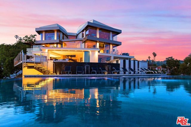 9380 Sierra Mar Drive Los Angeles, California Modern Architecture with all the latest & greatest amenities, built on one of the Bird Streets finest promontories with explosive views from downtown to the ocean & everything in between. This luxury residence is a true modern work of art located on a quiet cul-de-sac above the Sunset Strip. A spacious, luxurious master suite includes skylights, large closets, separate handbag & shoe rooms and American walnut flooring throughout. A Top-of-the-line Italian kitchen with amenities that include Thermador appliances, Caesarstone countertops, two ovens & two dishwashers. Dining area includes Tiffany dining table & Delfin swivel chairs. Outdoor entertainment deck boasts an 1,800 sq.ft. infinity pool, 8ft. fire pit, alfresco dining areas & more. Complete w/every modern amenity imaginable including a home theater w/seating for ten in plush reclining sofas, LED lighting, home automation system & a home gym. Live among the stars & titans of industry in the iconic trophy estate.