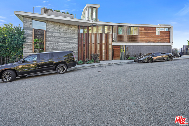 1979 Stradella Road Los Angeles, California This modern stunning architectural masterpiece is a dream for the most demanding Buyers in the Bel Air area! Featuring 5 bedrooms and 7 bathrooms with panoramic mountain and ocean views, the finishes include industrial steel, striated concrete, organic wood and walls of glass that burst out to the endless gorgeous vistas. The stylish design flows with open living and dining areas, a chefs kitchen, state-of-the-art theater, family room, fireplace, steam room and onyx bar join a wine room with 315-bottle display for ultimate home relaxation. The master suite includes a spa-like bathroom, large closet and balcony for enjoying romantic sunsets and blues of the ocean. Outdoor entertainment space has a beautiful infinity pool, spa, rooftop fire pit lounge and cocktail areas with unforgettable sparkling city lights! Property's hillside has a vineyard for home growing wine collection.