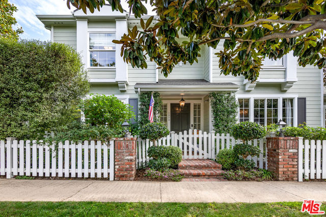 1059 Galloway Street Pacific Palisades, California Gorgeous Traditional on a corner lot in the Alphabet Streets of Pacific Palisades. This home (4 beds, 4.5 baths + converted bonus room above garage) offers tons of charm with contemporary touches, high ceilings, beautiful finishes, extensive built-ins throughout, private front and rear yards, and a guest house. Enter through the white picket fence up to the front porch and into the formal entry, and to your left is the light-filled living room with French doors leading to the yard, and to your right is the formal dining room with a double sided fireplace. Continue to the eat-in kitchen with built-in breakfast area, large island with Onyx, Arizona tile floors, honed granite counters, Viking appliances, and adjacent family room with cozy fireplace and built-ins with wine fridge and storage. A good-sized bedroom, powder room, and laundry room with pantry storage round out the first floor. Upstairs is the primary suite with soaking tub, separate shower, and huge walk-in closet along with two bedrooms separated by a jack-and-jill bathroom. Relax and play in the backyard that offers a built-in BBQ kitchen next to the patio, gorgeous landscaping, and play area/swing set. The detached 2-car garage with a great converted bonus room + bathroom above completes this beautiful home. Live the desired Palisades lifestyle close to the shops and restaurants of the Palisades Village.