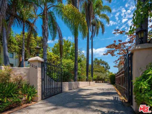 1018 Chautauqua Boulevard Pacific Palisades, California Exceptional Development / Building Opportunity in the heart of Pacific Palisades. This large lot located on the prestigious Chautauqua Rim is an Oasis with park like grounds. There are mature Palms, fruit trees and beautiful views. This is wonderful location for a building project within easy access to the Palisades Village, the Caruso project, restaurants, shops, library, park hiking and biking trails, Will Rogers, the beach and all this wonderful area has to offer. The current house and garage structures were built in 1931.