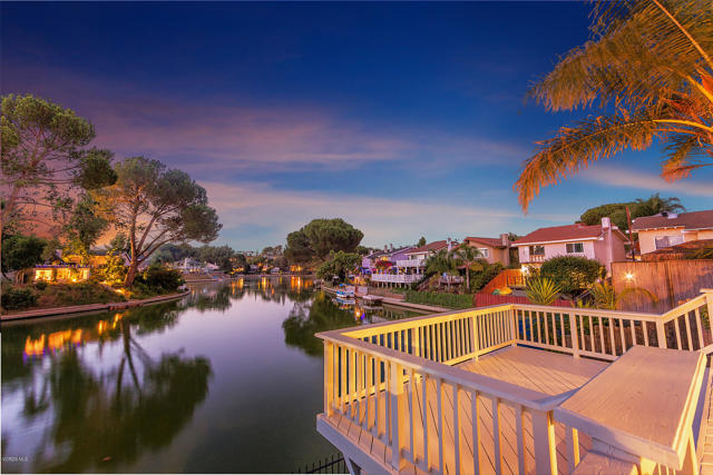 30721 Canwood Street Agoura Hills, California Enchanting and Romantic Lakefront Retreat-Like Charmer. FEATURING UNOBSTRUCTED MAIN CHANNEL VIEWS OF THE LAKE. As you enter the home you are instantly greeted by the spectacular LAKE and MOUNTAIN VIEW backdrop. A wall of glass sliding doors open up to the deck and views which fill the home with natural light and allow for seamless indoor - outdoor living. Queen palms frame a spacious split-level entertainers deck where you can instantly see yourself enjoying family and friends and hosting weekend BBQ'S. The kitchen overlooks a private courtyard with mountain view and opens to the dining area and main living space with stacked stone gas fireplace and stone hearth. Gorgeous kitchen features maple cabinetry, beveled glass display, granite, travertine, italian porcelain tile, desktop workspace and NEW LED under-cabinet lighting. NEW LED lighting throughout the entire residence. Powder room downstairs, Attached 2 car garage with cast iron sink and NEW epoxy shield garage floor coating. 3 bedrooms and 2 baths upstairs. Sweeping lake and mountain views from master suite boasting vaulted ceilings, his and her closets, private bath with jacuzzi tub, custom cabinetry with caesarstone and brushed nickel finish. The second bedroom shares sweeping lake and mountain views, the third bedroom with Santa Monica Mountain Views. NEWER 8k remodeled upstairs hall bath with custom tile and stone, granite. NEW industrial redwood fence with hard edge corrugated steel. NEW paint, newer carpet. Awesome unobstructed main channel view location with plenty of parking! Enjoy access to the Lake Lindero Country Club with swimming pool, clubhouse, 4 tennis courts and optional golf. Close to restaurants, shopping and trails. A short drive to beaches. Award winning Las Virgenes Schools. Enjoy lakeside living in the heart of desirable Agoura Hills.