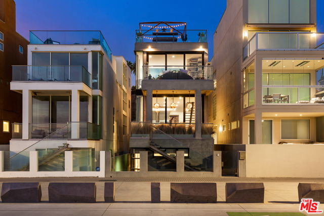 1335 Palisades Beach Road Santa Monica, California Quintessential California beach house on the sand in the heart of Santa Monica's historic Gold Coast. Warm, casual, inviting, whimsical, yet contemporary environment with clean lines, open floor plan, sun-filled spaces and floor to ceiling windows that take advantage of views that span from the Santa Monica Pier all the way to Point Dume in Malibu. Main level includes open cook's kitchen, dining and living room with high ceilings- all of which overlook the ocean and open to a covered private veranda, plus cozy media room/den with fireplace. There are 5 bedrooms and 4 1/2 baths, including a fabulous ocean front primary suite with terrace, marble bath and fitted closet. Other spaces and amenities include a fantastic top floor sunroom/gym that opens to a large roof terrace with spectacular views up and down the coast, a lower level guest room that opens to a private beach side patio, elevator, beautiful finishes & detailing and two-car direct access garage plus three car off street parking. A rare opportunity to live in a happy, exciting and chic home on a wide, sandy, quiet stretch of beach and enjoy beautiful Sunsets - all in close proximity to the Santa Monica pier and all the shops/restaurants on Ocean Avenue & the Third Street Promenade. The ideal California lifestyle!
