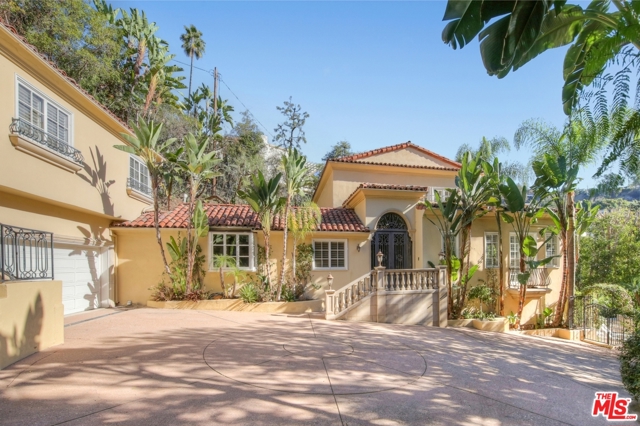 1710 Monte Cielo Court Beverly Hills, California A short drive from the Beverly Hills Hotel leads to the gates of this serene and sunny villa. Take a few steps up to the entry porch, push open the wrought-iron doors, and find yourself in a stately foyer. To the right is the large, high-ceilinged living room with luminous windows, Italianate fireplace, and hardwood floors. To the left lies the well-proportioned formal dining room w/ French doors opening to an intimate dining terrace & fountain. Beyond lies the chef's kitchen with a banquette, large pantry, and double Subzero. 2 ensuite bedrooms, a study, and a powder room complete the main level. The master suite occupies the entire upper floor w/ 2 balconies, 2 bathrooms, 2 walk-in closets. The lower level consists of a guest bedroom, 2 baths, bar/entertainment room which flows out to the salt-water infinity pool & spa. Massive ficus trees surround the grounds making them private and quiet. Separate guest house with 2 bedrooms and 2 baths. Two car garage and 5 car gated motor court.
